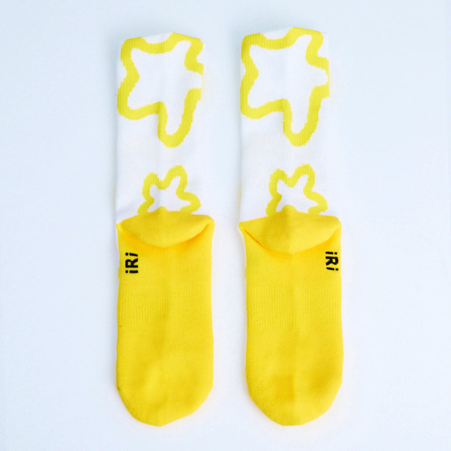 Yellow-white socks with iconic iRi abstract patterns on a white background